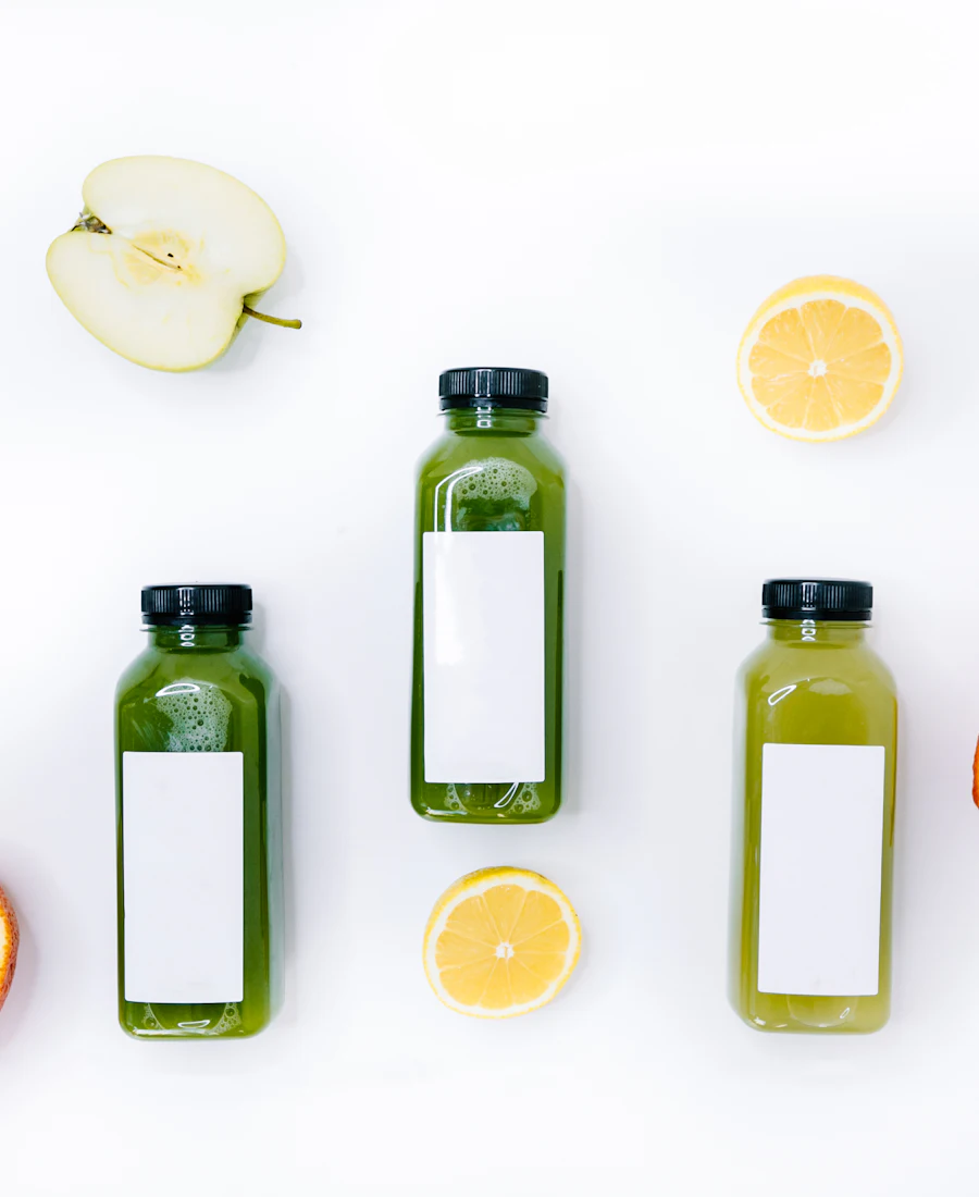 Bottles of fresh juice with lemon and orange