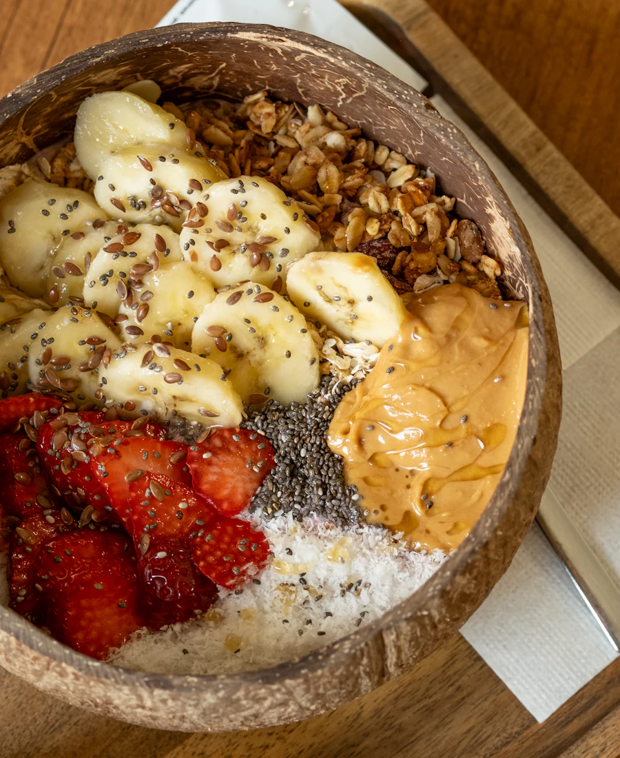 A smoothie bowl topped with fruit and granola